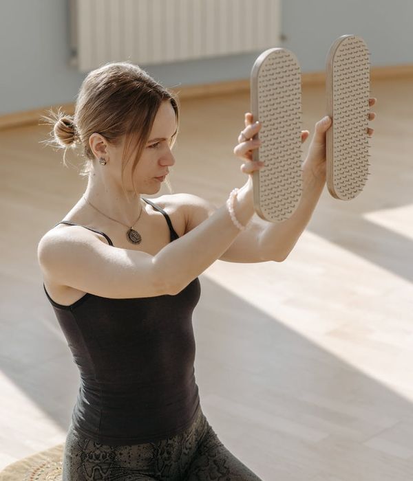 Woman in a fluid yoga pose, showing flexibility and calm.